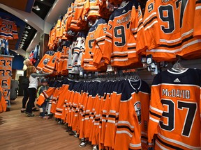 Deanna Ernst with her grandchildren, Keenan, 4 and Sierra Hall, 8, are going through the jersey display at the Oilers Store at Kingsway Garden Mall as the Oilers get ready for their season home opener Wednesday in Edmonton, October 3, 2017. Ed Kaiser/Postmedia