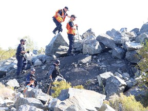 More than a dozen Greater Sudbury Police service officers fanned out across a hill neighbouring the Sunrise Ridge subdivision Tuesday to look for more evidence pertaining to the discovery of a human jawbone on the weekend.