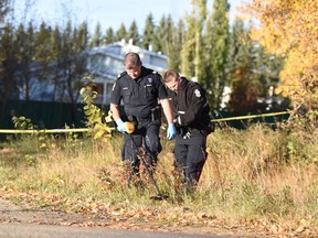 Edmonton Police looking for evidence at the scene near 44 Avenue and 211 Street, where an EPS member shot the driver of a car that rammed a police cruiser, on Wednesday, October 4, 2017. Shaughn Butts/ Postmedia