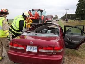 A male driver of a Honda Accord was injured after colliding with the front bucket of a tractor that had stalled while entering Ilderton Road on Wednesday. Mike Hensen/The London Free Press/Postmedia Network