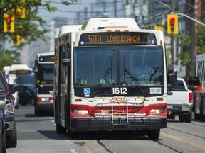 A TTC bus carries passengers along Queen St. W. in the Parkdale neighbourhood. (ERNEST DOROSZUK, Toronto Sun)