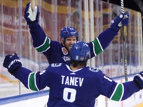 Vancouver Canucks' Alex Edler celebrates after teammate Chris Tanev scored a goal against the Los Angeles Kings during an NHL China exhibition game at the Cadillac Arena in Beijing on Sept. 23, 2017. (AP Photo/Mark Schiefelbein)