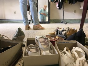 Elliot Ferguson/The Whig-Standard
Stef Relic looks at a pair of shoes she found on Wednesday at the annual Suit Up event, held by Dress for Success and Well Suited, that provides clothing for people in need of clothes for job interviews.