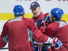 Montreal Canadiens' Alex Galchenyuk, left, and Brendan Gallagher listen to head coach Claude Julien during a practice on April 10, 2017 in Brossard, Que. (THE CANADIAN PRESS/Paul Chiasson)