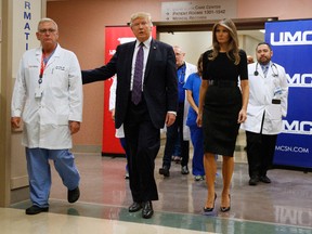 U.S. President Donald Trump and first lady Melania Trump walk with surgeon Dr. John Fildes at the University Medical Center after meeting with survivors of the mass shooting in Las Vegas on Wednesday, Oct. 4, 2017. (Evan Vucci/AP Photo)