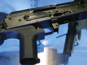 A little-known device called a "bump stock" is attached to a semi-automatic rifle at the Gun Vault store and shooting range Wednesday, Oct. 4, 2017, in South Jordan, Utah. Las Vegas shooter Stephen Paddock bought 33 guns within the last year, but that didn't raise any red flags. Neither did the mountains of ammunition he was stockpiling, or the bump stocks found in his hotel room that allow semi-automatic rifles to mimic fully automatic weapons. (AP Photo/Rick Bowmer)