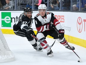 Los Angeles Kings defenceman Alec Martinez reaches in on Arizona Coyotes centre Clayton Keller during an NHL pre-season game on Sept. 28, 2017. (AP Photo/Mark J. Terrill)