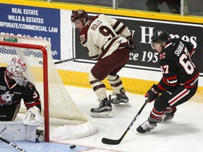 Peterborough Petes' Tyler Rollo overskates a rebound next to Niagara Ice Dogs' Zachary Shankar and goalie Colton Incze during first period OHL action on Sunday October 1, 2017 at the Memorial Centre in Peterborough, Ont. (Postmedia Network)