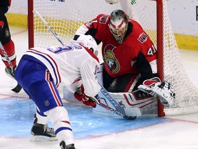 Montreal Canadiens' Peter Holland attempts to shove the puck under Ottawa Senators goaltender Craig Anderson during NHL pre-season hockey in Ottawa on Sept. 23, 2017. (THE CANADIAN PRESS/Fred Chartrand)