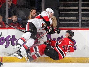 Mark Borowiecki of the Ottawa Senators checks Jacob Josefson of the New Jersey Devils in the first period of an NHL hockey game at Prudential Center on Feb. 21, 2017. (Paul Bereswill/Getty Images)