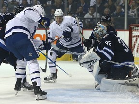 Goalie Steve Mason tracks the puck during the Jets’ season opener against the Maple Leafs last night at Bell MTS Place. (Kevin King/Winnipeg Sun)