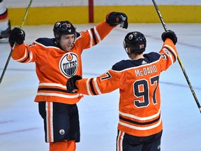 Edmonton Oilers Connor McDavid (97) celebrates with Leon Draisaitl (29) after scoring a hit trick against the Calgary Flames during the season opener of NHL action at Rogers Place in Edmonton, October 4, 2017.