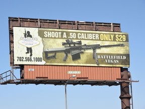 A billboard advertises a gun shooting range in Las Vegas, Nevada on Oct. 4, 2017. Mass killer Stephen Paddock used semi-automatic weapons which he modified with "bump-fire stock" to make them fire at the same speed as a fully automatic weapon when he killed 58 people and injured over 500 in the worst mass shooting in modern American history on Oct. 1, 2017 at a country music festival in Las Vegas.