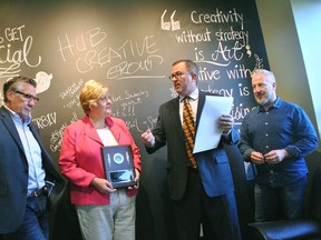 Coun. Darrin Canniff (centre right) proclaims HUB Creative Group as the Feature Industry for September. He’s with owners Ike Erickson (left), Mary Genge and John Lyons at the Lacroix Street business.