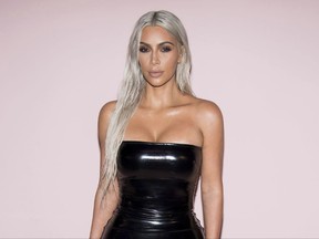 In this Sept. 6, 2017 file photo, Kim Kardashian West attends the Tom Ford show as part of NYFW Spring/Summer 2018 in New York. Kardashian West is confirming that she and Kanye West are having a third child. She appears in a short video released Thursday for “Keeping Up With the Kardashians” where she is speaking with her sister Khloe on a video chat. At one point during the call, she tells her sister, “We’re having a baby!” (Photo by Charles Sykes/Invision/AP, File)