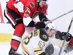 Ottawa Senators defenceman Mark Borowiecki takes down Boston Bruins left winger Brad Marchand during NHL playoff action in Ottawa on April 15, 2017. (THE CANADIAN PRESS/Sean Kilpatrick)