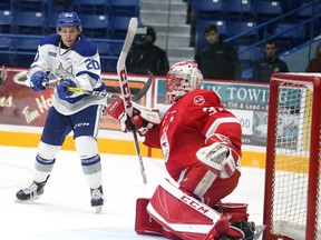 Shane Bulitka of the  Sudbury Wolves gets set to redirect the puck in front of Soo Greyhounds goalie Matthew Villalta  during OHL in Sudbury, Ont. on Sunday October 1, 2017. Gino Donato/Sudbury Star/Postmedia Network