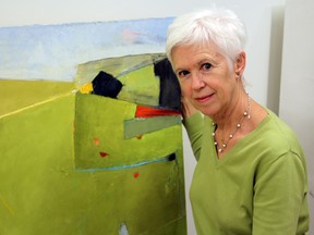 Artist Caroline Marshall is seen during setup on Sunday for the Organization of Kingston Women Artists’ show at the Tett Centre.