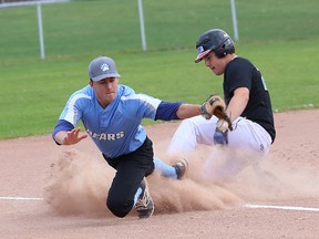 Eric Frappier, right, of l'Horizon Aigles, slides safe into third as Ben Rain, of St. Benedict Bears, waits for the throw during high school baseball action at the Terry Fox Sports Complex in Sudbury, Ont. on Thursday October 5, 2017. John Lappa/Sudbury Star/Postmedia Network