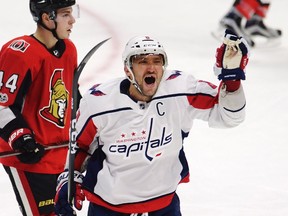 Washington Capitals left winger Alex Ovechkin celebrates his third goal of the game as Ottawa Senators centre Jean-Gabriel Pageau looks on during NHL action in Ottawa on Oct. 5, 2017. (THE CANADIAN PRESS/Adrian Wyld)