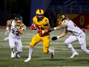 Queen's Golden Gaels receiver Alex Zulys (88) gains yardage after catching a pass from quarterback Nate Hobbs during the first quarter of an Ontario University Athletics football game Thursday night at Richardson Stadium, the first Gaels night game at the stadium. (Ian MacAlpine/The Whig-Standard/Postmedia Network)