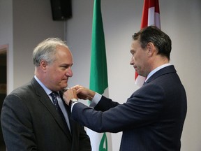 John Lappa/Sudbury Star/Postmedia Network
Marc Trouyet, right, Consul General of France in Toronto, bestows the Knight in the Order of the Academic Palms of the French Republic to Pierre Riopel during a ceremony in Sudbury on Thursday. Riopel is the former president of College Boreal.
