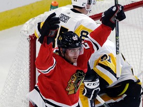 Chicago Blackhawks left wing Brandon Saad celebrates after scoring his first goal during the first period of an NHL hockey game against the Pittsburgh Penguins, Thursday, Oct. 5, 2017, in Chicago. (AP Photo/Nam Y. Huh)