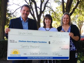 Steve Baker, president of Union Gas, Jodi Maroney, executive director of the Chatham-Kent Hospice Foundation and Melanie Watson, the volunteer coordinator for Chatham-Kent Hospice, hold up a $20,000 cheque that Union Gas has donated to the hospice's volunteer program.