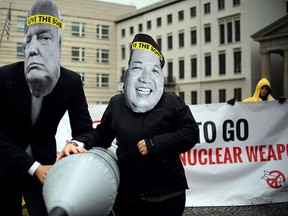 In this Sept. 13, 2017 file photo activists of the International Campaign to Abolish Nuclear Weapons (ICAN) protest against the conflict between North Korea and the USA with masks of the North Korean ruler Kim Jong Un, right, and the U.S. president Donald Trump, left,  in front of the US embassy in Berlin, Germany. (Britta Pedersen/dpa via AP)
