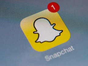 This file photo shows the logo of mobile app "Snapchat" displayed on a tablet on January 2, 2014 in Paris. (Lionel Bonaventure/Getty Images)