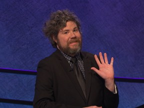 In this undated handout photo provided by Jeopardy Productions, Inc., Austin Rogers waves during a taping of "Jeopardy!" in Culver City, Calif. Rogers, a New York City bartender, extended his run of wins to eight on the show that aired Oct. 5, 2017, and boosted his total winnings to more than $300,000. (Jeopardy Productions, Inc. via AP)