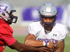 Western running back Cedric Joseph takes a handoff in practice from Kevin John at TD stadium. (MIKE HENSEN, The London Free Press)