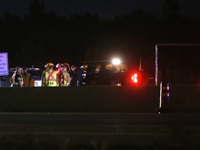 Emergency services respond to a crash in the eastbound lanes of Highway 401 near the Sydenham Road interchange in Kingston, Ont. on Thursday, Oct. 5, 2017. The crash happened in a construction zone where three lanes of traffic merge into two lanes. 
Elliot Ferguson/The Whig-Standard/Postmedia Network