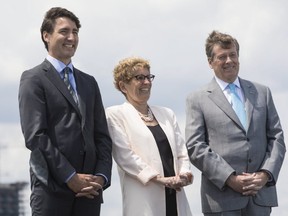 Canadian Prime Minister Justin Trudeau (left), Ontario Premier Kathleen Wynne and Toronto Mayor John Tory attend a news conference along Toronto's waterfront on Wednesday, June 28 , 2017. (THE CANADIAN PRESS/Chris Young)