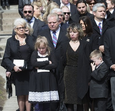 Renata Ford watches with her kids, Stephanie and Dougie, as her husband Rob Ford's casket pass by at St. James Cathedral in Toronto on Wednesday, March 30, 2016. (Craig Robertson/Toronto Sun)