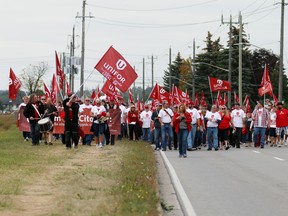 Striking Cami workers march Friday in a rally outside the Ingersoll plant. As the dispute nears its fourth week, there’s no end in sight. GM Canada and Unifor remain “far apart,” says the union representing the 2,800 workers. The two sides are to resume bargaining on Tuesday. (BRUCE CHESSELL/Sentinel-Review)