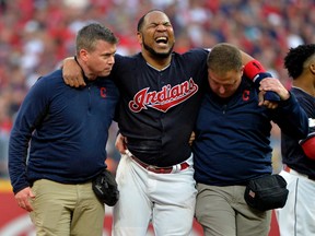 Indians' Edwin Encarnacion is carried off the field after rolling his ankle at second base during the second inning of Game 2 of the American League Division Series against the Yankees in Cleveland on Friday, Oct. 6, 2017. (Phil Long/AP Photo)