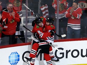 Blackhawks centre Nick Schmaltz (left) celebrates with right wing Patrick Kane (right) after scoring a goal during against the Penguins during first period NHL action in Chicago on Thursday, Oct. 5, 2017. (Nam Y. Huh/AP Photo)