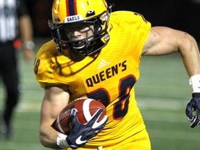 Queen's Golden Gaels running back Jake Puskas runs for yardage against the Waterloo Warriors during OUA Sport football action at Richardson Stadium in Kingston on Thursday. Queen's won 68-17. (Ian MacAlpine/The Whig-Standard)