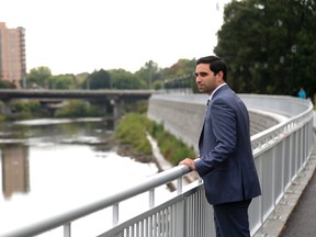 Peter Fragiskatos, Liberal MP for London North Centre, looks over the newly finished section of the West London Dike, which runs north from the Queens Avenue bridge on the north branch of the Thames River. (MIKE HENSEN, The London Free Press)