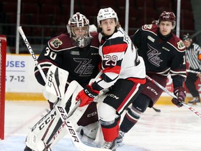 67's forward Tye Felhaber gets tangled up with Petes netminder Dylan Wells during Friday's OHL game at TD Place arena.