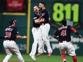 Indians starting pitcher Josh Tomlin celebrates with Yan Gomes, second from right, after Gomes hit a game-winning RBI single in the 13th inning of Game 2 of the American League Division Series against the Yankees in Cleveland on Friday, Oct. 6, 2017. (David Dermer/AP Photo)