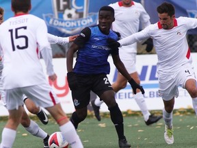 FC Edmonton midfielder Abraham Dukuly, centre, dribbles the ball between three members of the San Francisco Deltas in North American Soccer League play at Clarke Stadium on Sunday, Oct. 1, 2017.