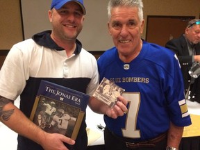 Winnipegger Ryan Soroka on the left, holds a 45-year-old photo of his dad, Jonas and himself as a one-year-old baby. Soroka met Jonas on Friday for the first time since that day. (Paul Friesen/Winnipeg Sun)