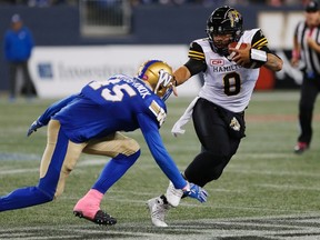 Tiger-Cats' Jeremiah Masoli runs for the first down against Blue Bombers' Jovan Santos-Knox (45) during first half CFL action in Winnipeg on Friday, Oct. 6, 2017. (John Woods/The Canadian Press)