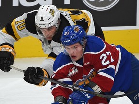 Edmonton Oil Kings forward Trey Fix-Wolansky (27) gets held by Brandon Wheat Kings forward Kale Clague (10) during WHL action at Rogers Place in Edmonton, October 6, 2017.
