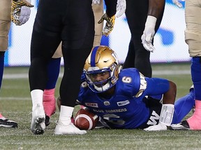 Winnipeg Blue Bombers quarterback Dominique Davis (6) looks up at the feet of Hamilton Tiger-Cats' Nikita Whitlock after being sacked by on Friday night. (THE CANADIAN PRESS/John Woods)