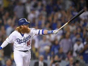 Los Angeles Dodgers third baseman Justin Turner watches his three-run home run against the Arizona Diamondbacks in Los Angeles, Friday, Oct. 6, 2017. (AP Photo/Mark J. Terrill)