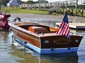 In this undated file photo provided by Guernsey’s, is John F. Kennedy’s speedboat, Restofus. (Guernsey’s via AP)