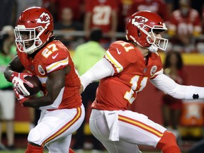 Kansas City Chiefs running back Kareem Hunt and quarterback Alex Smith are among the top candidates for the league’s offensive player award so far. (AP Photo/Charlie Riedel)